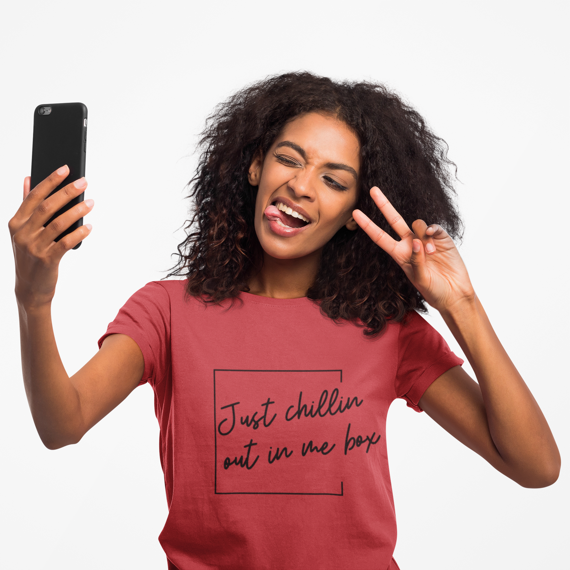 Woman taking a selfie while wearing a red One Direction inspired t-shirt printed with the Niall Horan quote “Just chillin out in me box” in a outlined square.