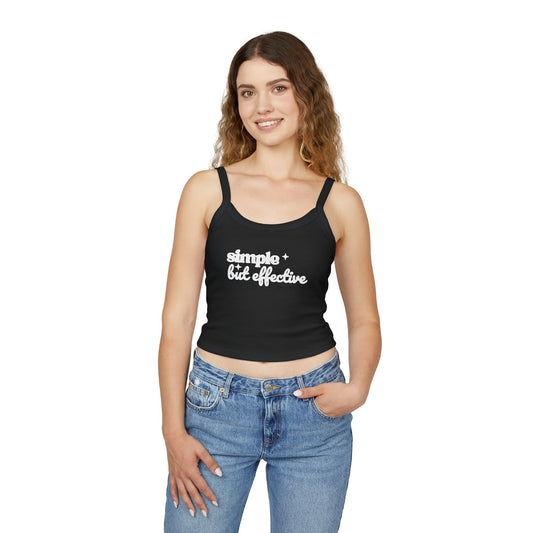 Woman wearing a black One Direction inspired crop tank with the Harry Styles quote “simple but effective” printed in white text.