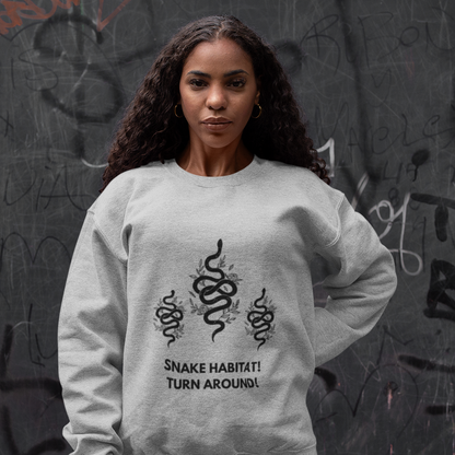 Woman wearing a gray One Direction inspired sweatshirt with Liam Payne’s “Snake Habitat! Turn Around!” design printed with three black snakes.