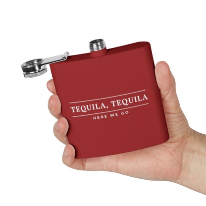 Red One Direction inspired flask held in one hand with the Liam Payne quote “Tequila, Tequila Here We Go” printed in white.
