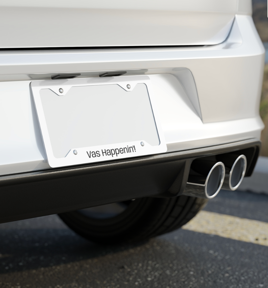 Silver One Direction inspired license plate frame installed on the back of a car with the Zayn Malik quote “Vas Happenin’!” printed along the bottom.