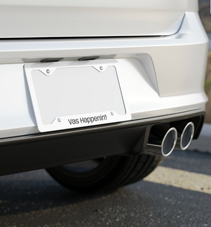 Silver One Direction inspired license plate frame installed on the back of a car with the Zayn Malik quote “Vas Happenin’!” printed along the bottom.