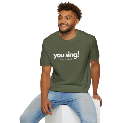 Man wearing an olive green One Direction inspired t-shirt featuring the Niall Horan quote “you sing! since 2013” in white text.